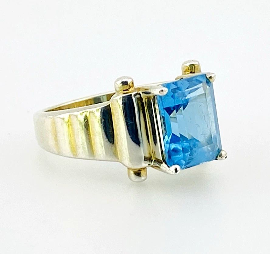 Emerald-cut blue topaz sterling silver ring with fluted architectural shoulders, signed LP, size 7.75