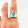 Emerald-cut blue topaz sterling silver ring with fluted architectural shoulders, signed LP, size 7.75