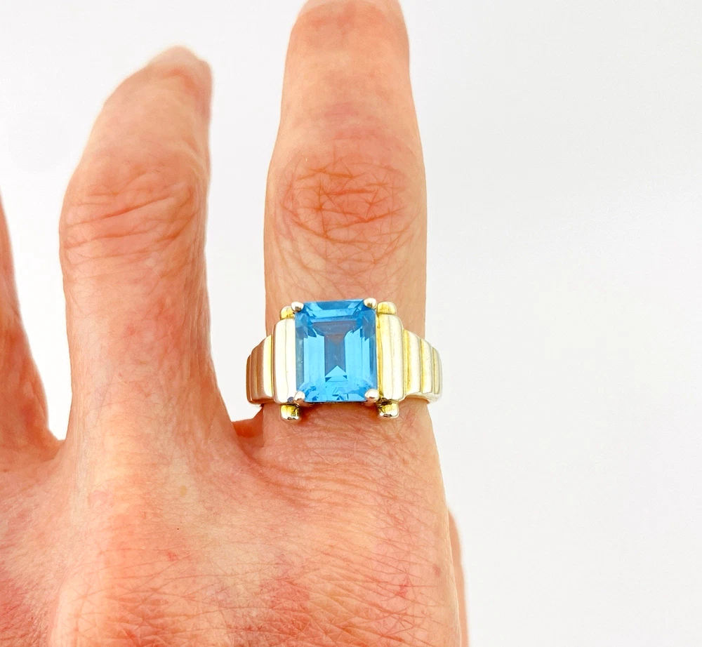 Emerald-cut blue topaz sterling silver ring with fluted architectural shoulders, signed LP, size 7.75