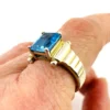 Emerald-cut blue topaz sterling silver ring with fluted architectural shoulders, signed LP, size 7.75