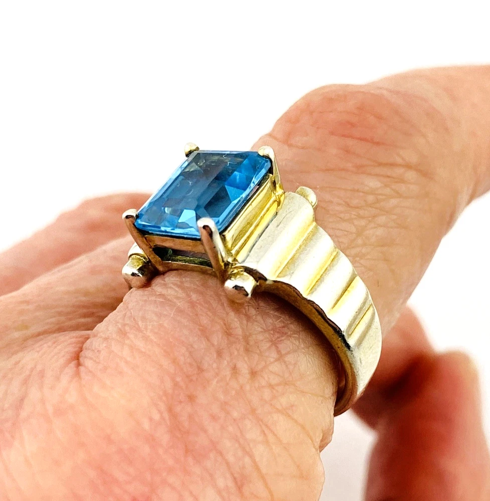 Emerald-cut blue topaz sterling silver ring with fluted architectural shoulders, signed LP, size 7.75