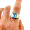 Emerald-cut blue topaz sterling silver ring with fluted architectural shoulders, signed LP, size 7.75