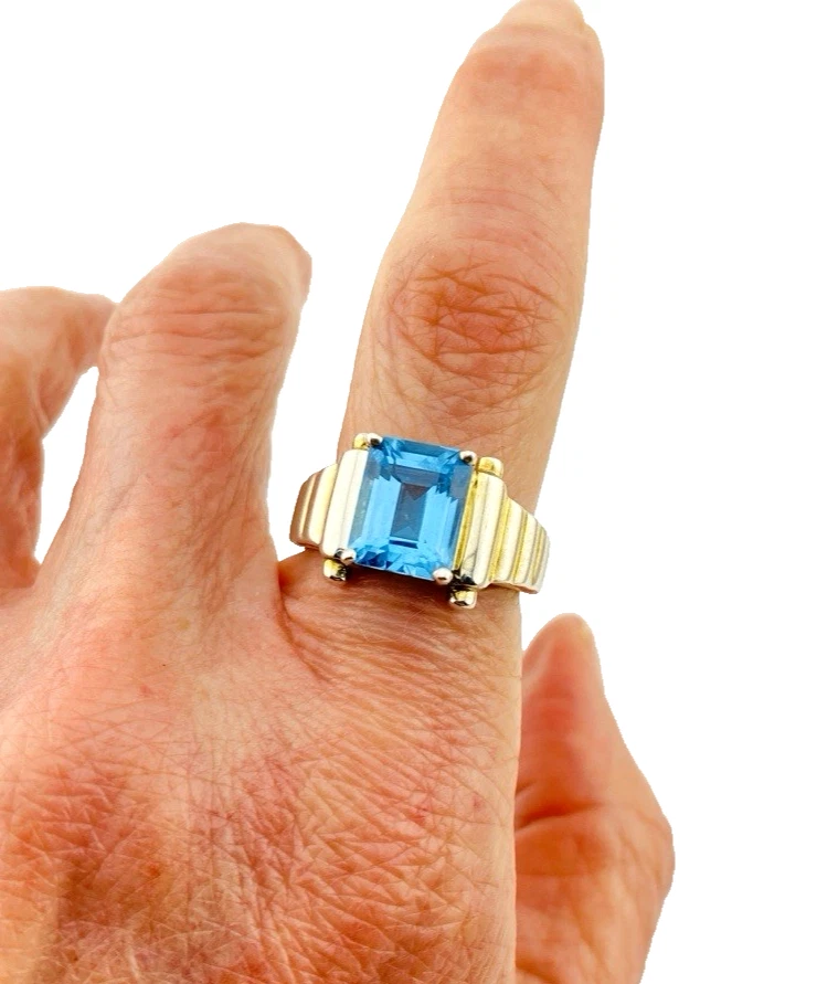 Emerald-cut blue topaz sterling silver ring with fluted architectural shoulders, signed LP, size 7.75