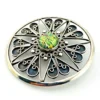 Circular vintage RN Mexican sterling silver brooch pendant with green, blue, and gold dichroic glass cabochon and radial wirework