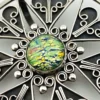 Circular vintage RN Mexican sterling silver brooch pendant with green, blue, and gold dichroic glass cabochon and radial wirework