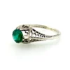1920s sterling silver filigree ring with a round faceted emerald-green glass stone