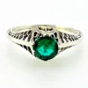 1920s sterling silver filigree ring with a round faceted emerald-green glass stone