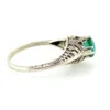 1920s sterling silver filigree ring with a round faceted emerald-green glass stone