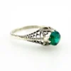 1920s sterling silver filigree ring with a round faceted emerald-green glass stone
