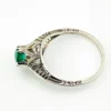 1920s sterling silver filigree ring with a round faceted emerald-green glass stone