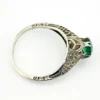 1920s sterling silver filigree ring with a round faceted emerald-green glass stone