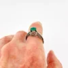 1920s sterling silver filigree ring with a round faceted emerald-green glass stone