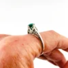 1920s sterling silver filigree ring with a round faceted emerald-green glass stone