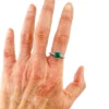 1920s sterling silver filigree ring with a round faceted emerald-green glass stone
