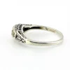 Sterling silver ring with a round blue sapphire, diamond accents and openwork shoulders