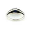 Sterling silver ring with a round blue sapphire, diamond accents and openwork shoulders