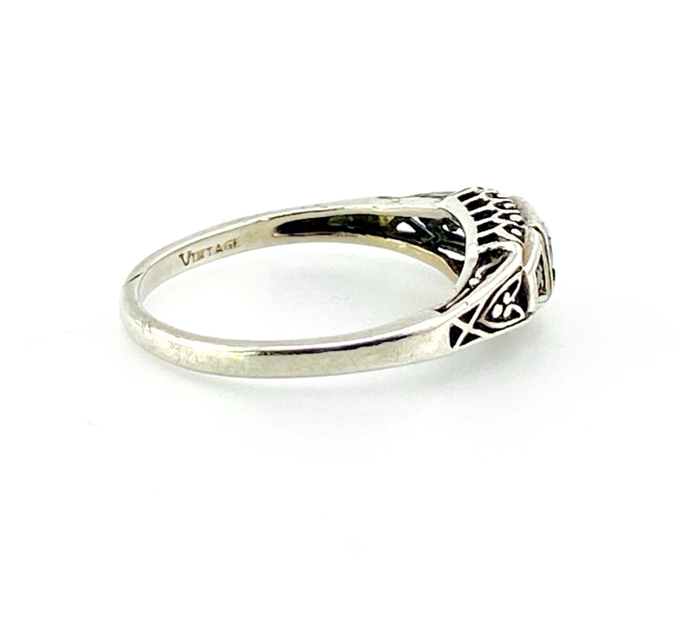 Sterling silver ring with a round blue sapphire, diamond accents and openwork shoulders