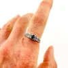 Sterling silver ring with a round blue sapphire, diamond accents and openwork shoulders