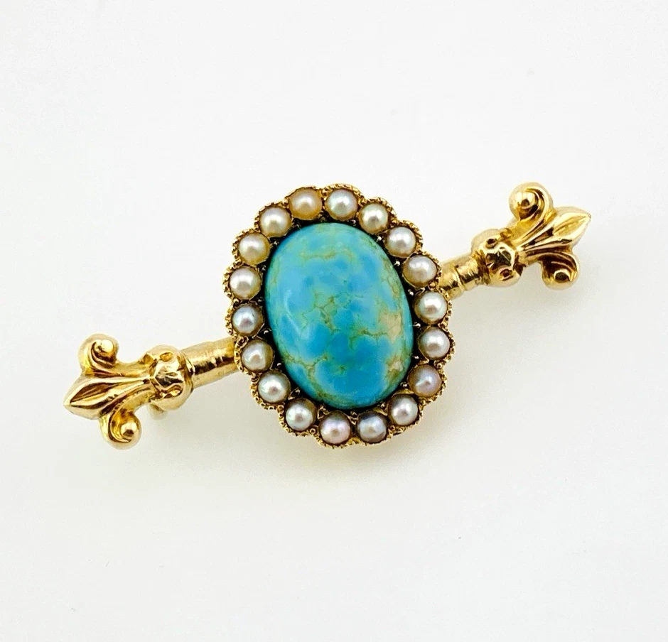 Late Victorian 14k gold brooch with oval turquoise, natural seed-pearl halo, and fleur-de-lis ends