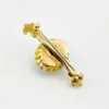 Late Victorian 14k gold brooch with oval turquoise, natural seed-pearl halo, and fleur-de-lis ends