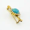 Late Victorian 14k gold brooch with oval turquoise, natural seed-pearl halo, and fleur-de-lis ends