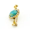 Late Victorian 14k gold brooch with oval turquoise, natural seed-pearl halo, and fleur-de-lis ends