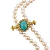 Late Victorian 14k gold brooch with oval turquoise, natural seed-pearl halo, and fleur-de-lis ends