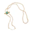 Late Victorian 14k gold brooch with oval turquoise, natural seed-pearl halo, and fleur-de-lis ends
