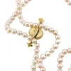 Vintage cultured pearl necklace styled with an antique turquoise and seed-pearl bar pin sold separately