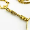 Vintage gold-plated magnifying loupe necklace with an adjustable slide and 30-inch scroll-link chain