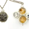 WWII-era sterling silver forget-me-not locket opened to reveal four original family photographs