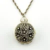 WWII-era sterling silver forget-me-not locket opened to reveal four original family photographs