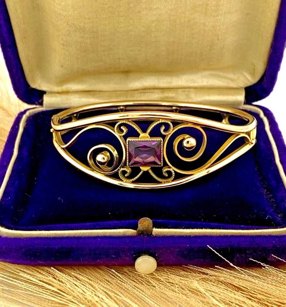 Circa 1950s gold-filled openwork clamper bracelet with rectangular amethyst glass stone and scroll decoration