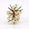 Circa 1960s hand-fabricated 14k gold Atomic starburst ring with natural pear-shaped opals and diamond accents