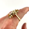 Circa 1960s hand-fabricated 14k gold Atomic starburst ring with natural pear-shaped opals and diamond accents