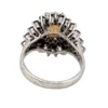 Oval natural opal surrounded by tiered blue sapphires in a white gold plated sterling silver princess cluster ring
