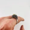 Oval natural opal surrounded by tiered blue sapphires in a white gold plated sterling silver princess cluster ring