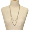 Long 800 silver guard chain with ribbon-bound sheaf links, swivel dog clip, and spring ring, shown doubled on a mannequin