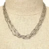 Long 800 silver guard chain with ribbon-bound sheaf links, swivel dog clip, and spring ring, shown doubled on a mannequin