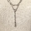 Long 800 silver guard chain with ribbon-bound sheaf links, swivel dog clip, and spring ring, shown doubled on a mannequin