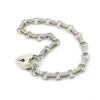 Slender sterling silver gate-link bracelet with ribbed bars, open connectors, and a heart padlock clasp