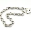 Slender sterling silver gate-link bracelet with ribbed bars, open connectors, and a heart padlock clasp