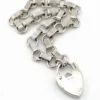 Slender sterling silver gate-link bracelet with ribbed bars, open connectors, and a heart padlock clasp