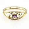 Circa 1950s gold-filled openwork clamper bracelet with rectangular amethyst glass stone and scroll decoration