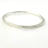 Sculptural Mexican silver bangle narrowing from 5mm to 2mm along the sides