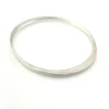 Sculptural Mexican silver bangle narrowing from 5mm to 2mm along the sides