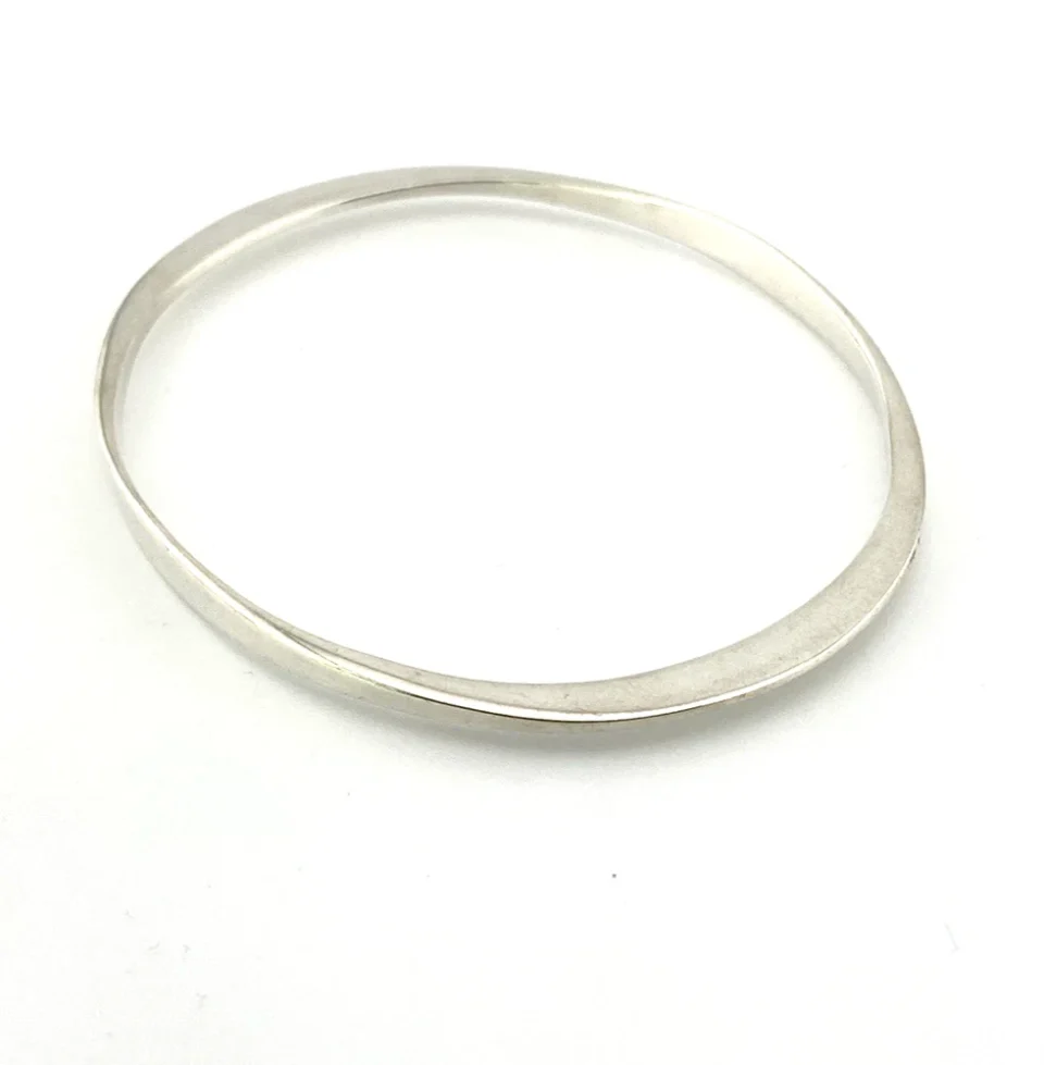 Sculptural Mexican silver bangle narrowing from 5mm to 2mm along the sides
