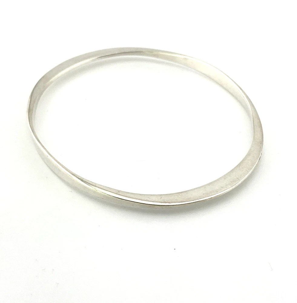 Sculptural Mexican silver bangle narrowing from 5mm to 2mm along the sides