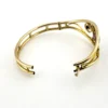Circa 1950s gold-filled openwork clamper bracelet with rectangular amethyst glass stone and scroll decoration