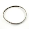Eight-inch sterling silver crescent-pattern bangle showing its slightly irregular round shape